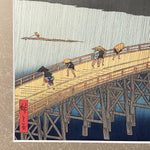 Load image into Gallery viewer, Sudden Shower over Shin-Ohashi bridge and Atake (Woodblock Print)
